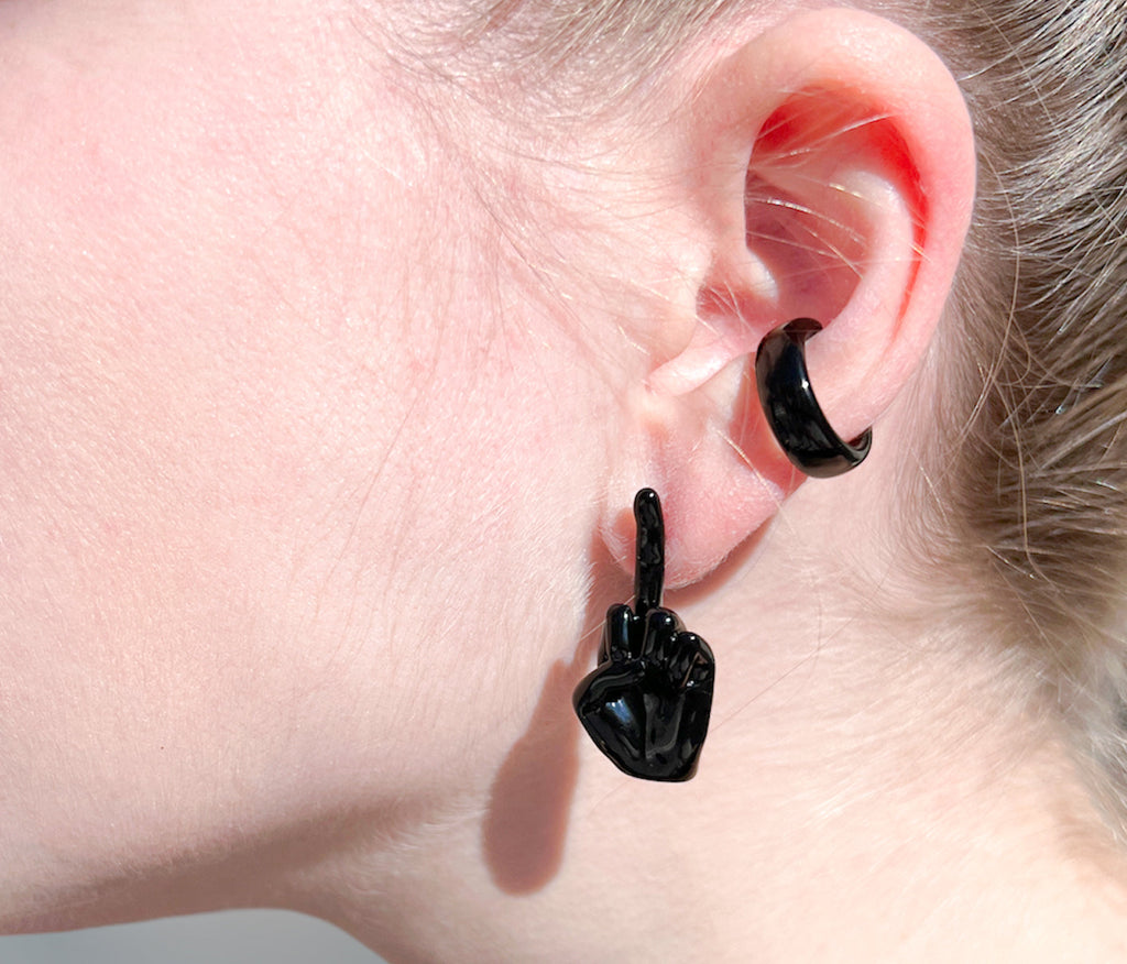 goth jewelry, black enamel middle finger earring and black enamel ear cuff on ear 