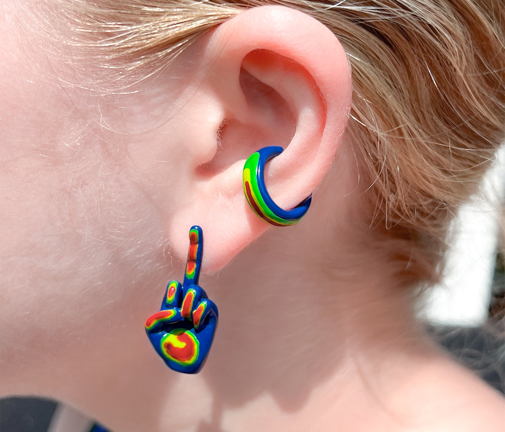 Chunky rainbow ear cuff on ear paired with our rainbow middle finger stud earring . colors : blue, green, yellow and red