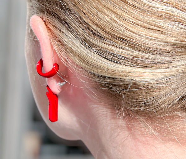Chunky devils red ear cuff on ear with goth red hand stud earring. Hand-painted enamel.