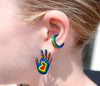 Chunky rainbow ear cuff paired with our rainbow hand waving stud earring on ear. colors : blue, green, yellow and red